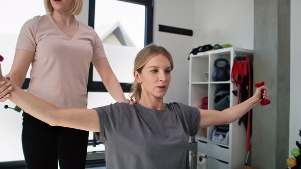 Caucasian female patient exercising on exercising ball and  holding weights. Shot with RED helium ca