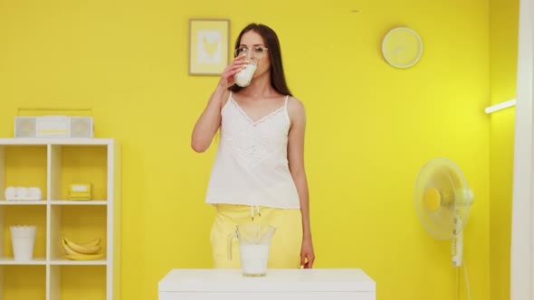 Young Woman Is Drinking Milk Looking At Camera