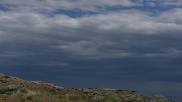 Time lapse over clouds moving over coast