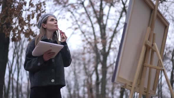 Thoughtful Creative Young Beautiful Woman Standing in Autumn Cloudy Park Looking Away Walking to