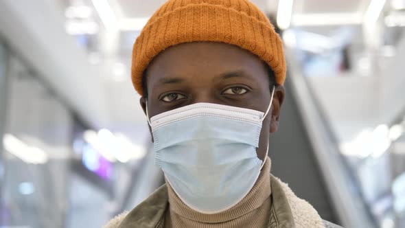 A Closeup Portrait of an AfricanAmerican Man Wearing a Medical Coronavirus Protective Mask Looks