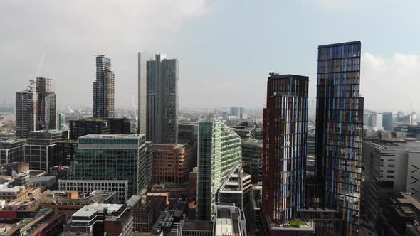 Aerial view, flying over tall building near Liverpool Street Station on a hazy sunny day