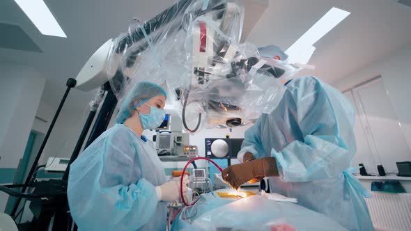 Surgeon doing operation to a patient