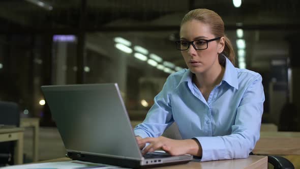 Tired Woman Checking Time on Watch, Working Overhours in Office to Meet Deadline