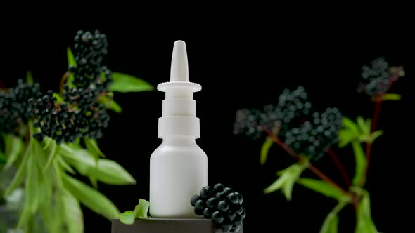 Nasal Spray On Turntable Against Black Background, Medicine Bottle Made From Black Berries.