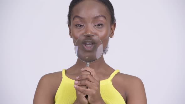 Young Happy African Woman Playing with Magnifying Glass