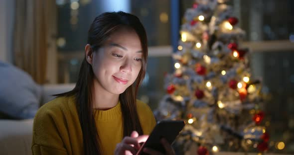 Woman send blessing message on cellphone at Christmas time