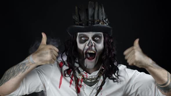 Sinister Man with Halloween Skeleton Makeup in Shirt with Blood Celebrating, Showing Thumbs Up