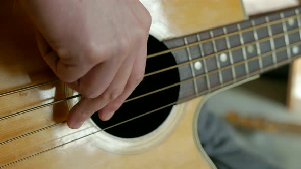 Man playing acoustic bass in living room.