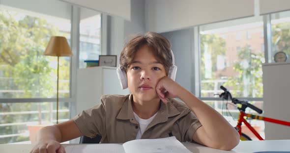 Caucasian Teen Boy Wearing Headphones Learning Online