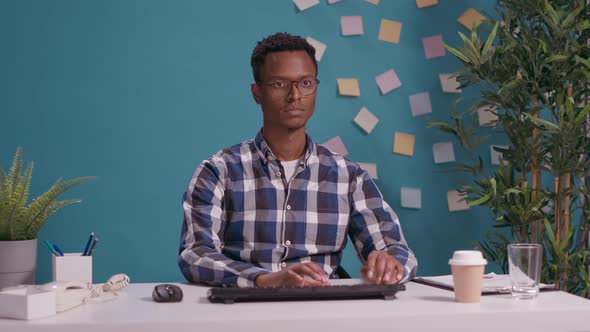 Portrait of African American Man Using Computer at Desk