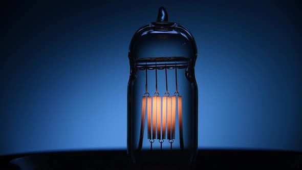 Electric Vintage Edison Light Bulb with a Spiral Flashing on a Blue Background