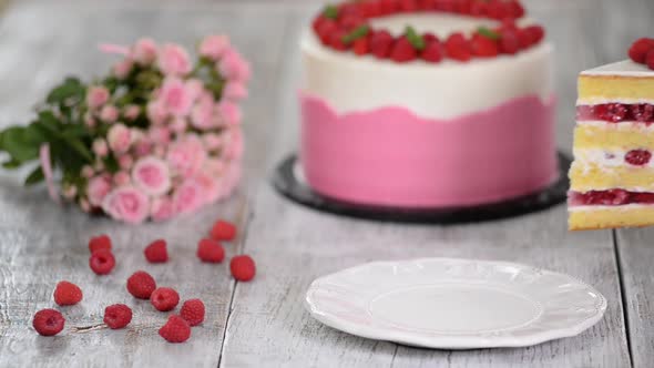 Piece of delicious raspberry cake with fresh raspberries.	