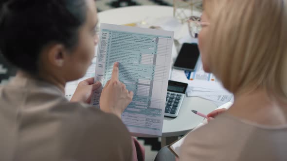 Women Analyzing Tax Declaration Together