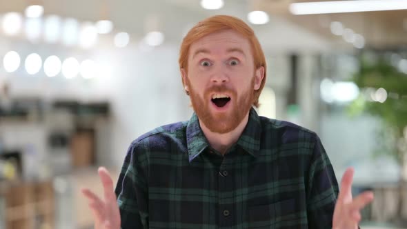 Portrait of Excited Beard Redhead Man Celebrating Success Cheering