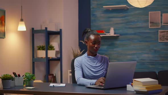 African Freelancer Working From Home Overtime at Laptop