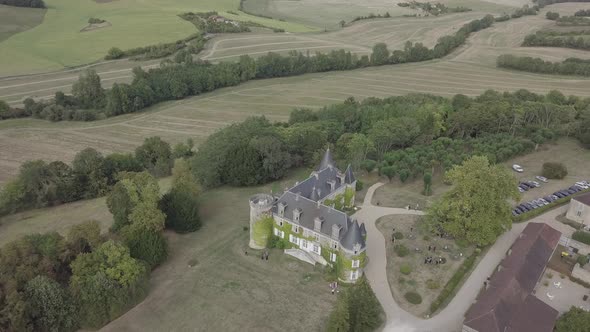 Aerial view of french castle Chateau de La Cote Rural summer landscape green meadows fields trees 