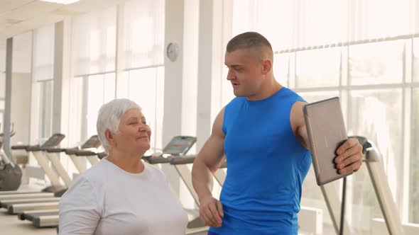 An Elderly Woman is Photographed on a Tablet Video Call Rest After Training Sends Greetings to