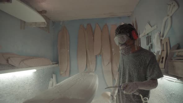 Professional Craftsman Making Surfboard