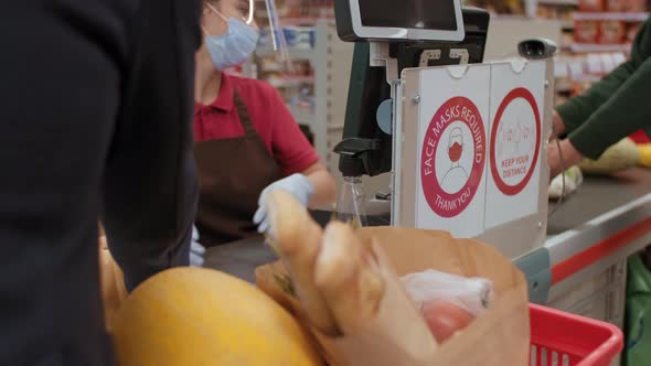 Cashier Scanning Products In Hypermarket