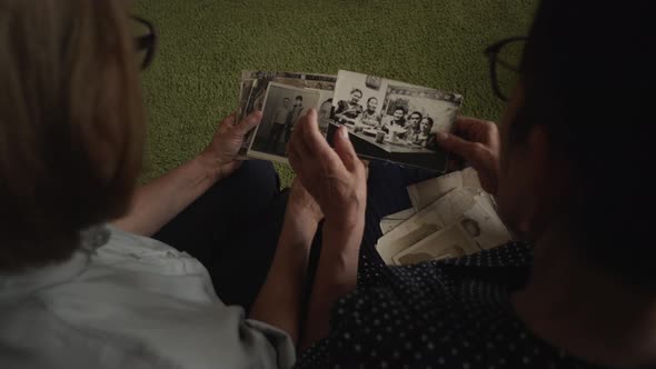 Mature Daughter Visits Senior Mother and Watching Family Photo Album