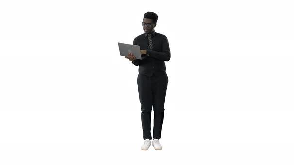 Confident African American Businessman Typing on Laptop on White Background.