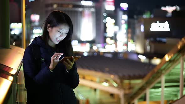 Woman use of cellphone at outdoor