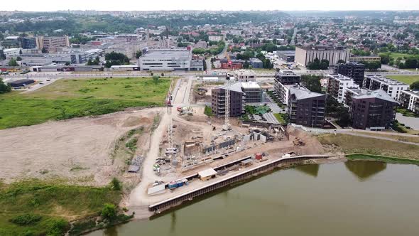 Kaunas city rooftops and construction site of apartment building with cranes