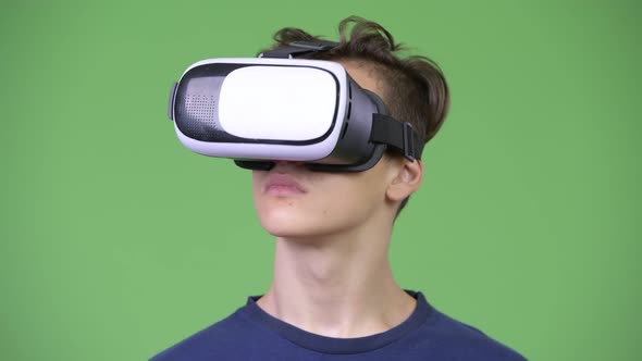 Young Handsome Teenage Boy Using Virtual Reality Headset