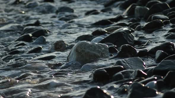 Sea Waves Bathing Pebbles and Stones