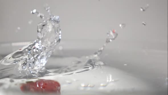 Three Strawberries Drop Into Water