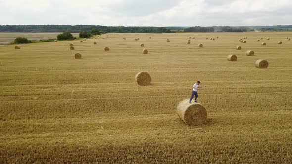 Child on a Field Against Straw