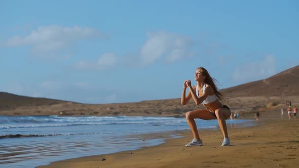 Sportswoman Wearing Sportswear Doing Squats Exercise Outdoors