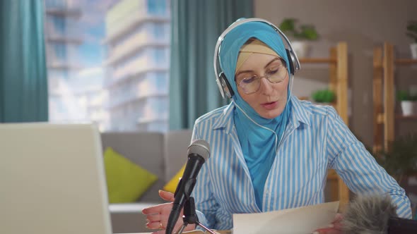 Portrait Young Muslim Woman Records a Podcast While Sitting in Front of a Microphone in Her Living