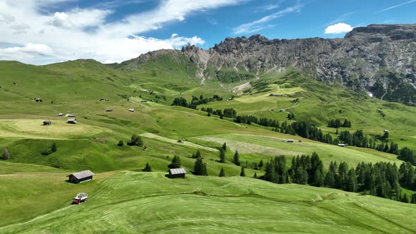 Wooden cottages under the mountains on a sunny summer day