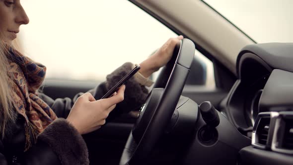 Texting And Driving.Woman Using Phone On Car Mobile.Female Writing Message In Vehicle.Driving Car