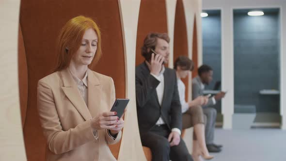 Portrait of Cheerful Caucasian Businesswoman Using Phone