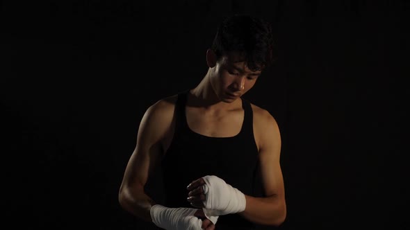 Male Boxer Wrapping Bandages On His Hands Before Fight