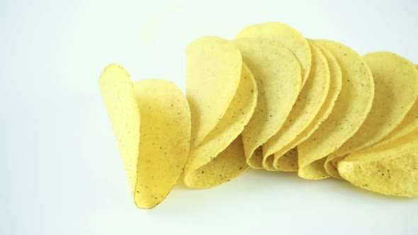 Yellow corn taco shells on a white background.