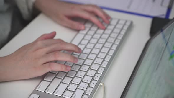 Close up female hand typing on keyboard