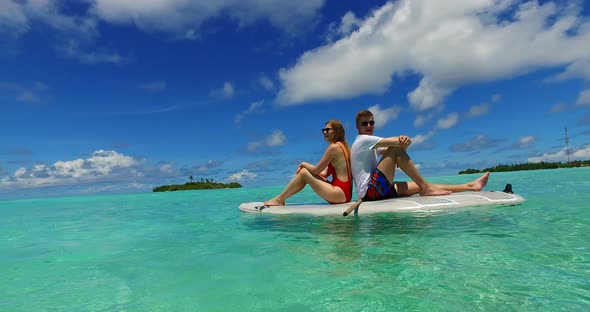 Romantic man and woman after marriage in love enjoy life on beach on sunny white sandy background