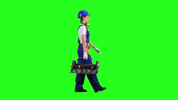 Professional Girl Carries a Case with Construction Tools. Green Screen. Side View