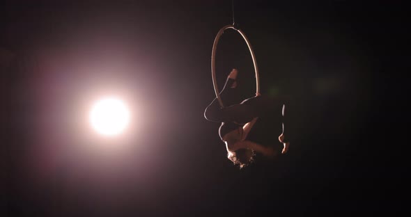 Girl Gymnast Hanging on the Acrobatic Ring Making Performance Show