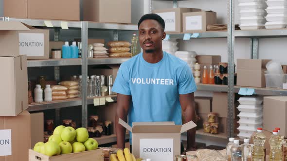 African American Man Preparing Boxes for Donation