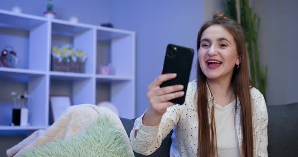 Smiling Vlogger Girl Looking at Mobile Make Video Call Shooting Vlog Taking Selfie