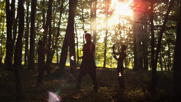 Contre jour of persons spinning fire umbrellas, Ultra Slow Motion