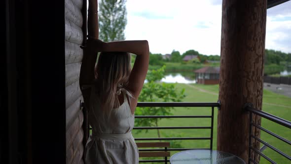 Tracking Shot of Slim Young Caucasian Woman Walking to Handrails on Terrace at Tourist Resort