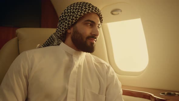 Smiling Muslim Man Posing in Private Plane