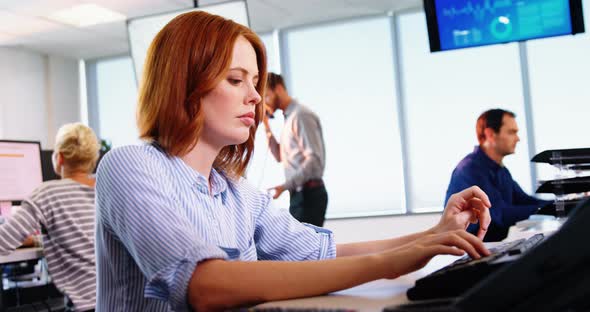 Female executive working on computer at desk