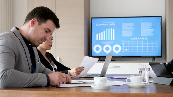 Businessman Reading Then Signing a Contract